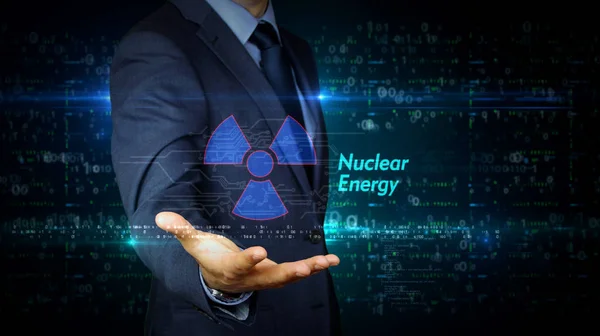Touch screen uomo d'affari con ologramma simbolo di energia nucleare — Foto Stock