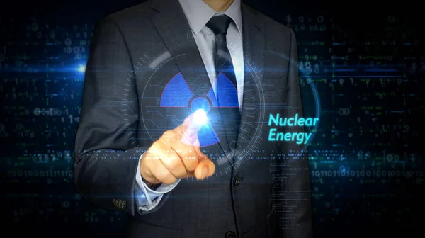 Touch screen uomo d'affari con ologramma simbolo di energia nucleare — Foto Stock