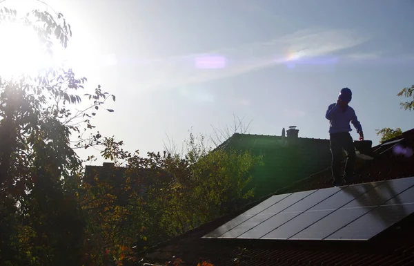 Technician installs solar panels on the roof