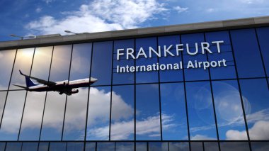 Frankfurt, Almanya, Avrupa 'ya iniş yapan bir jet uçağı. Cam havaalanı terminali ve uçağın yansıması ile şehre varış. Seyahat, iş ve turizm konsepti.
