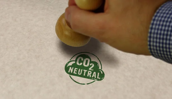 CO2 carbon neutral emission stamp and stamping hand. Ecology, nature friendly, climate change, green fuel and earth protect concept.