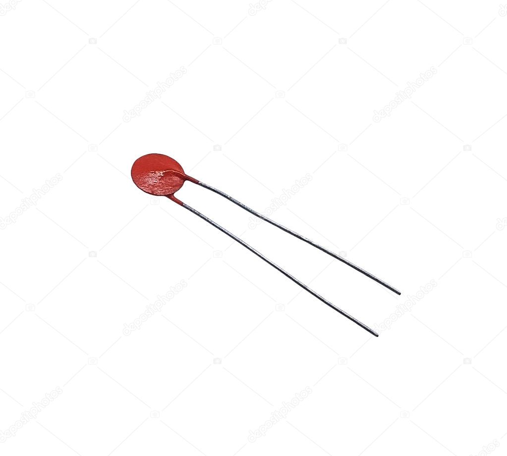 Orange capacitor on the white background for websites, banners, flyers. Isolated electrical component for semiconductor