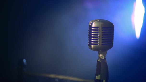 View of concert vintage glow microphone stay on stage under bright spotlight and Smoke. Close up — Stock Video