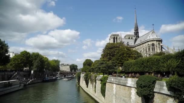 Pohled na katedrskou katedru Notre Dame je na řece s turistickou lodí — Stock video