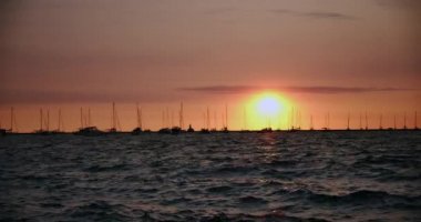 Sunset Dock İskelesi, tekne ve yatlar gün batımında suda hareket 4k yavaş hareket