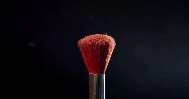 Two Make-up brush with powder on black background Colour Paint Concept Slow Motion. — Stock Video