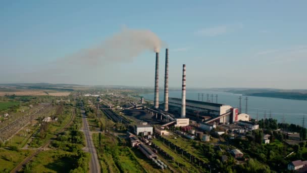 Aerial drone view of high chimney pipes with grey smoke from coal power plant. wide view — Stock Video