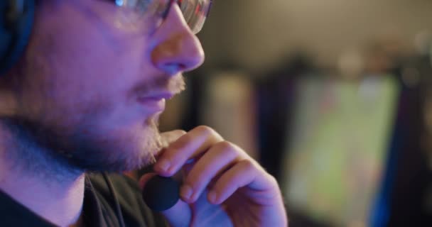 Close up Ritratto di un giocatore che gioca a un videogioco online e commenta in un microfono, — Video Stock