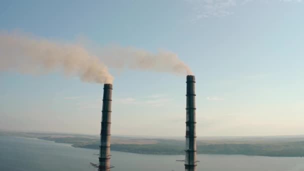 Aerial drone view of high chimney two pipes with grey smoke from coal power plant. Close up V2 — Stock Video