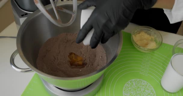 Misturador Chicotes Creme de chocolate para bolo. Assadeira profissional preparando a massa de bolo, adiciona ovos crus, fazendo creme. Close-up V2 — Vídeo de Stock