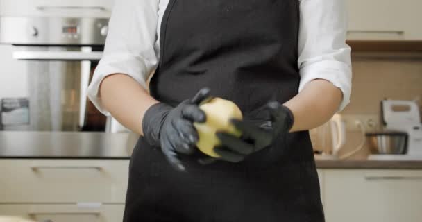 Κλείσε. Σεφ χέρια σε μαύρα γάντια προετοιμασία της τούρτας ή βάζοντας ζύμη πίτσα επί του σκάφους. V2 — Αρχείο Βίντεο
