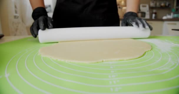 De cerca. Chef manos en guantes negros preparando el pastel o poniendo masa de pizza a bordo. V4 — Vídeo de stock