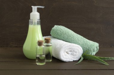 Sıvı sabun ve ahşap arka plan üzerinde iki havlu