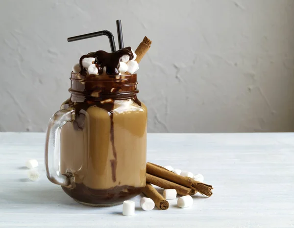 Coffee dessert drink with marshmallow and cinnamon