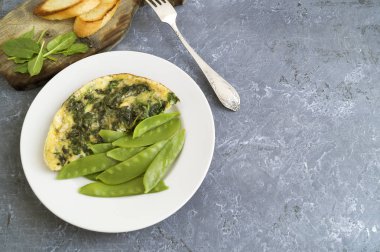 Ispanak ve yeşil bezelye ile omlet.