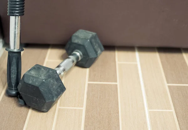 dumbbell and fitness tools on the room at home