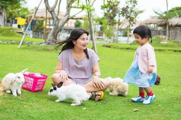 little girl and mother with rabbit