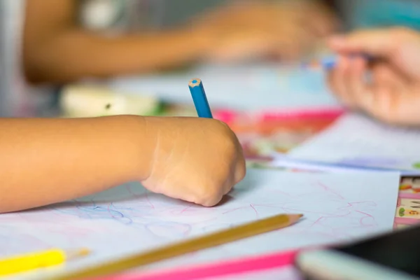 close up hand child drawing picture on the table