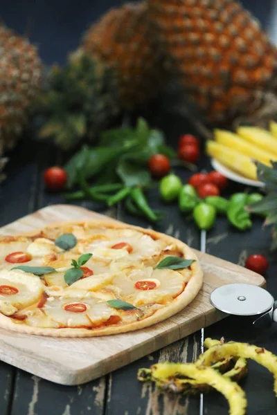 Pineapple pizza served with wine