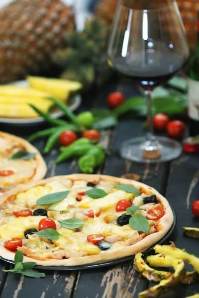 Pineapple pizza served with wine