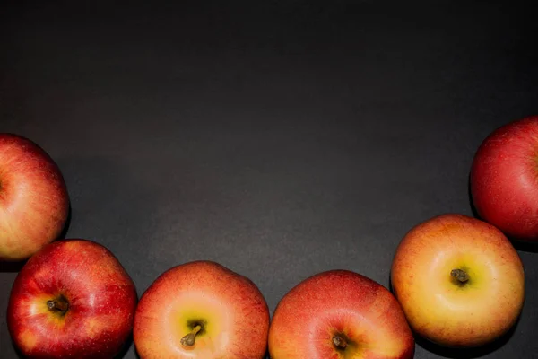 Red juicy apples. Ripe red apples on black background. Beautiful apples are ideal shape. Top view with space for your text. Red apples background. Mock up. Close up. Natural. Juice. Fresh eat. Summer fruits. Healthy lifestyle. Organic food.