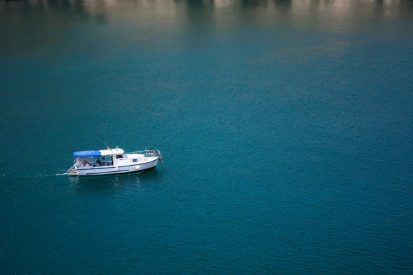 A sailing boat is in the sea. Isolated. Seascape background.  Yachts at the sea surface. Aerial view of luxury floating boat on blue Adriatic sea at sunny day. Travel - image