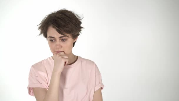 Beautiful teenage girl or young woman thinking, white background — Stock Video