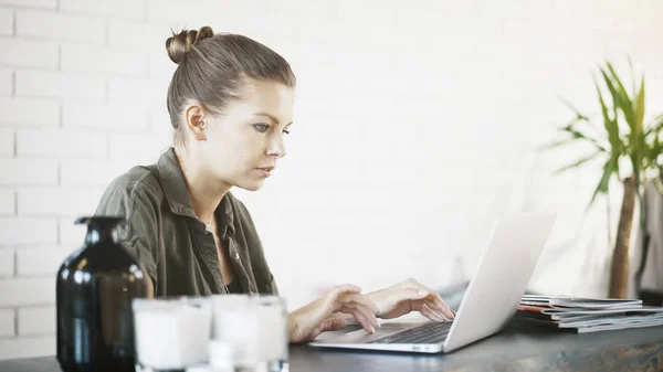 Een manager van de jonge vrouw thuis werken met een laptop — Stockfoto
