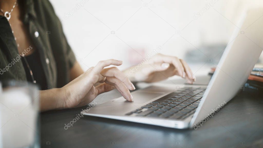 Close up of woman hands with a laptop at home