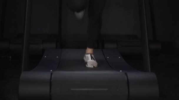 Woman s legs in white sneakers jogging on treadmill — Stock Video