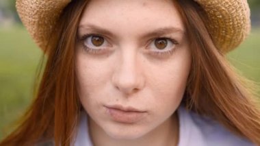 Dış kameraya bakarak ve yanıp duran genç zencefil kadın yakın çekim