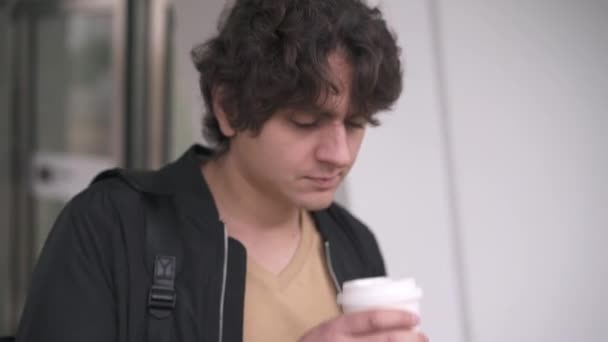 Man drinking coffee waiting for train — Stock Video