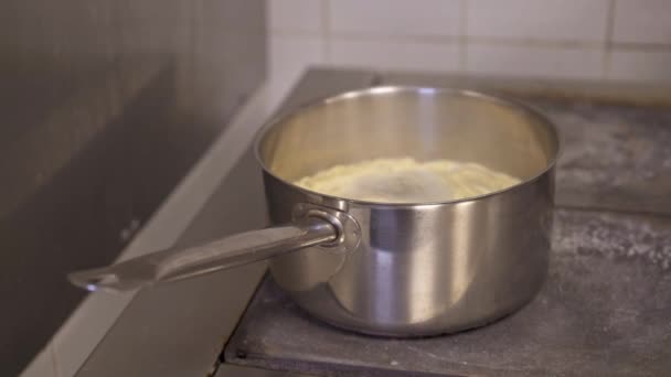 Silver kitchen pot with rolled pasta spaghetti in boiling water — Stock Video