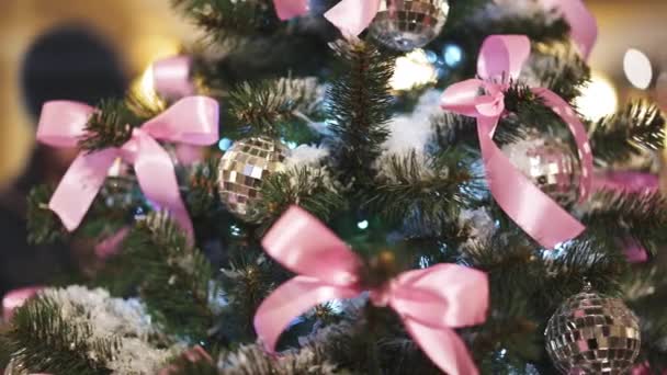 Árbol verde de Navidad artificial con nieve artificial decorado con bolas de plata y cintas — Vídeo de stock