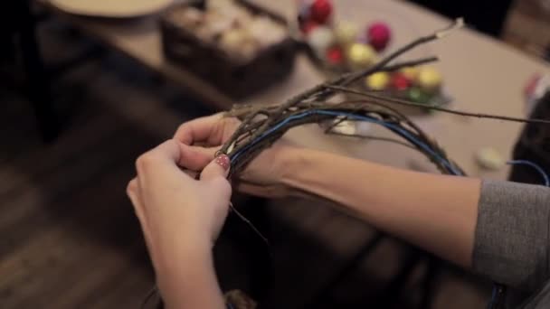 Γυναικεία χέρια που δένουν ξύλινες ράβδους με ένα σύρμα για Χριστουγεννιάτικο στεφάνι — Αρχείο Βίντεο
