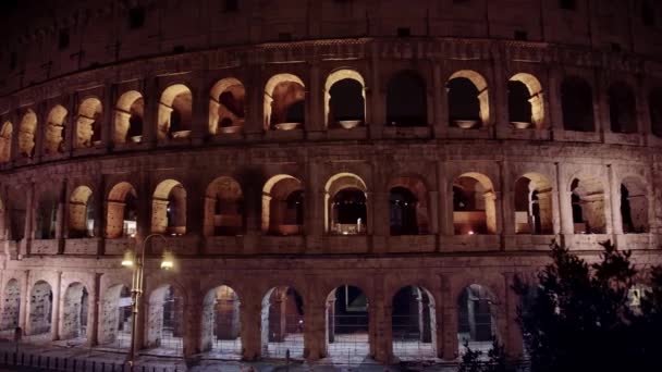 ローマ・コロッセオ・コロシアム・フラビアン・アンフィシアター・アンフィテテロ・フラヴィオ・コロッセオは、イタリア・ローマの中心部にある楕円形の円形劇場です。夜の時間。右から左パンリアルタイムミディアムショット — ストック動画