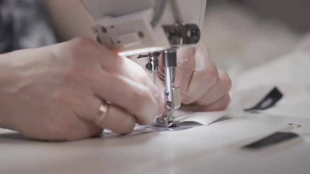 Close up of inserting needle into the sewing machine and stitching white fabric — Stock Video