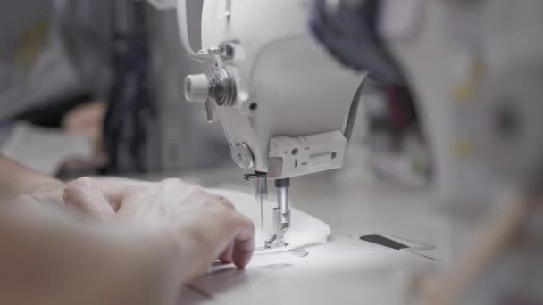 Handheld close up of adult female hands sewing stitch curved edge — Stock Video