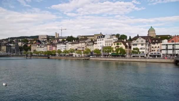 ZURICH, SUÍÇA - ABRIL 2019: Slow pan shot of Zurique old town center and Limmat in spring time at daylight — Vídeo de Stock