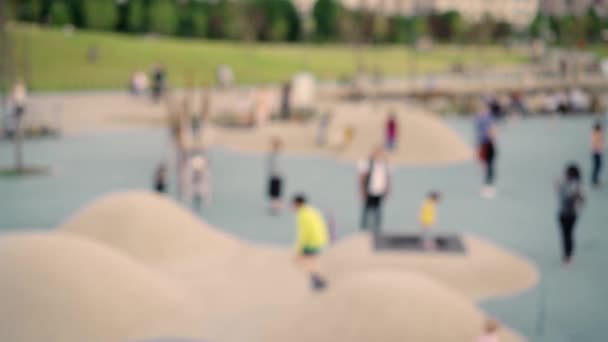 Pan shot of blurred modern children playground in daylight — ストック動画