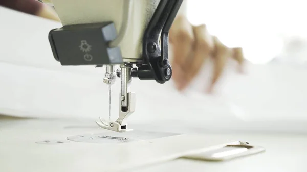 Sewing on machine, close up of hands and white cloth — Stock Photo, Image