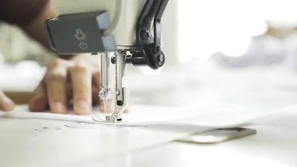 Sewing on machine, close up of hands and white cloth — Stock Photo, Image