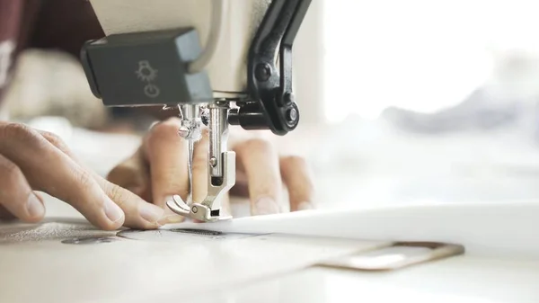 Sewing on machine, close up of hands and white cloth — Stock Photo, Image