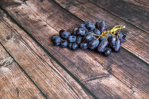 Vetőmag nélküli vörös szőlő a fa asztal tetején. — Stock Fotó