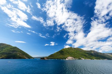 Meryem kaya ve komşu Adaları Körfezi Kotor, Karadağ üzerinde Sveti Dordje kilise üzerinde parlak mavi gökyüzü.