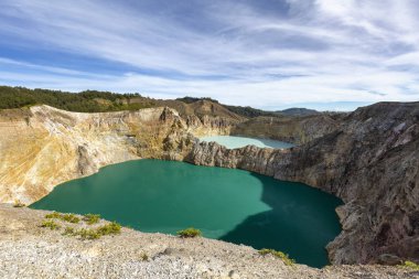 View of the two of the three tri-colored lakes on the peak of Ganung Kelimutu National Park in Flores, Indonesia.  clipart