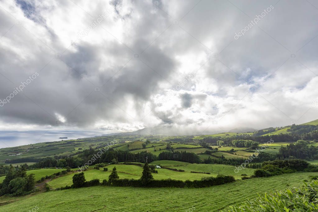 Pastures with beautiful clouds in the summertime near Vila Franca do Campo in the Azores, Portugal. 