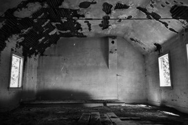 Terk edilmiş eski bir kilise içinin bir siyah beyaz resim. 