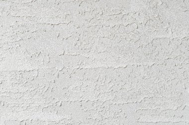 Kırmızıdaki dokunun soyut bir görüntüsü bir sıva duvarı.