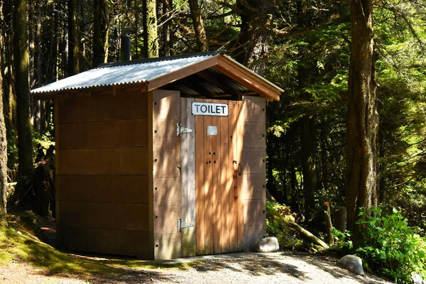 An image of an old wooden outdoor public toilet in a wooded area. — Stock Image Image Old Wooden Outdoor Public Toilet Wooded Area Stock Image